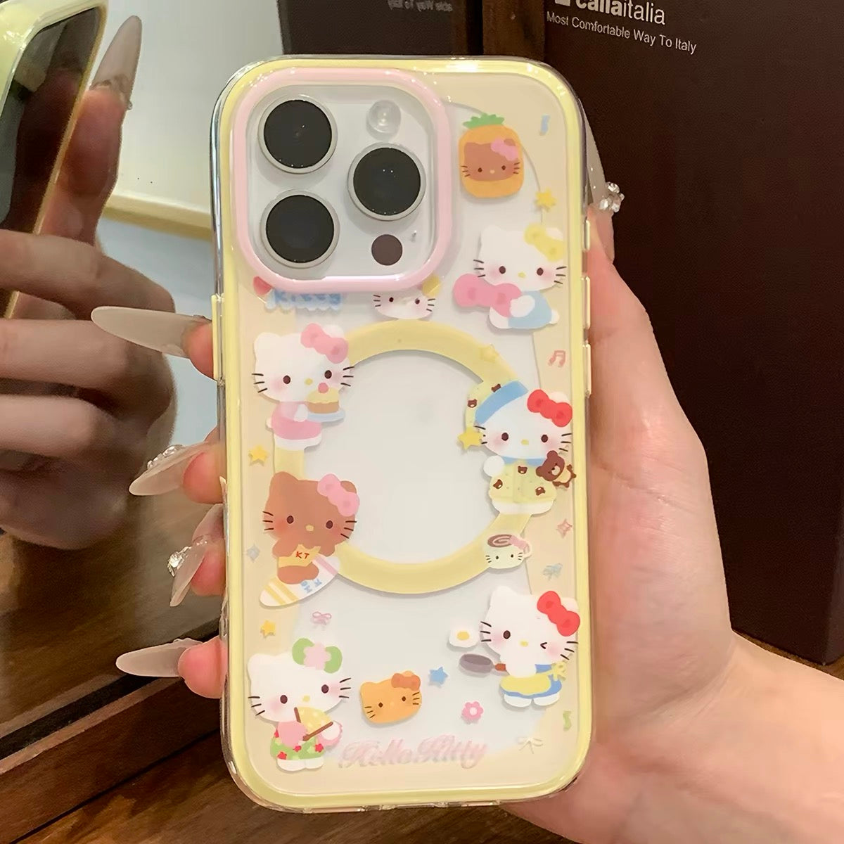 Phone case with yellow trim, kitten design, and built-in magnetic stand for daily use.