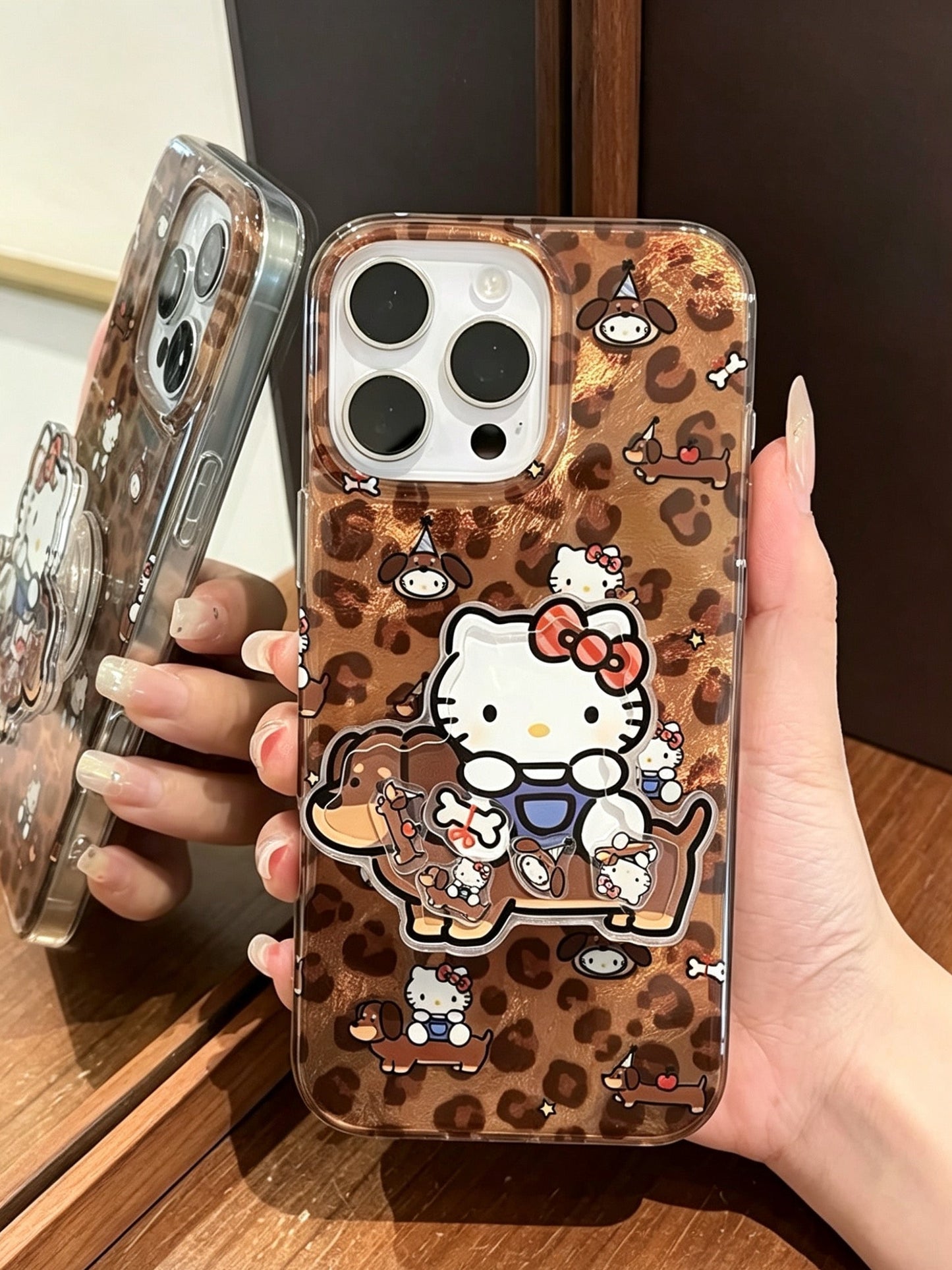 Brown leopard-print phone case featuring a dachshund and Hello Kitty, with a built-in stand.