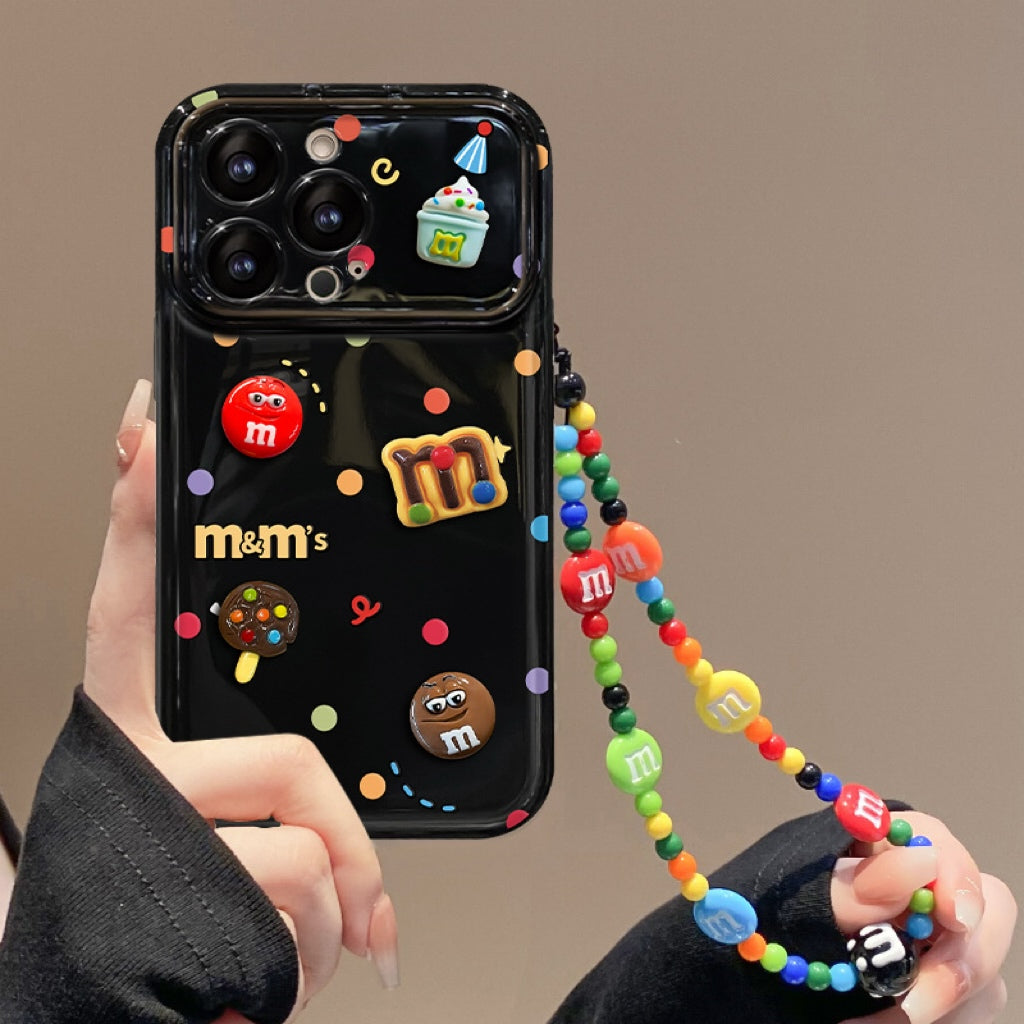 Polka-dot M&M character phone case with a flip-out mirror and wrist strap.