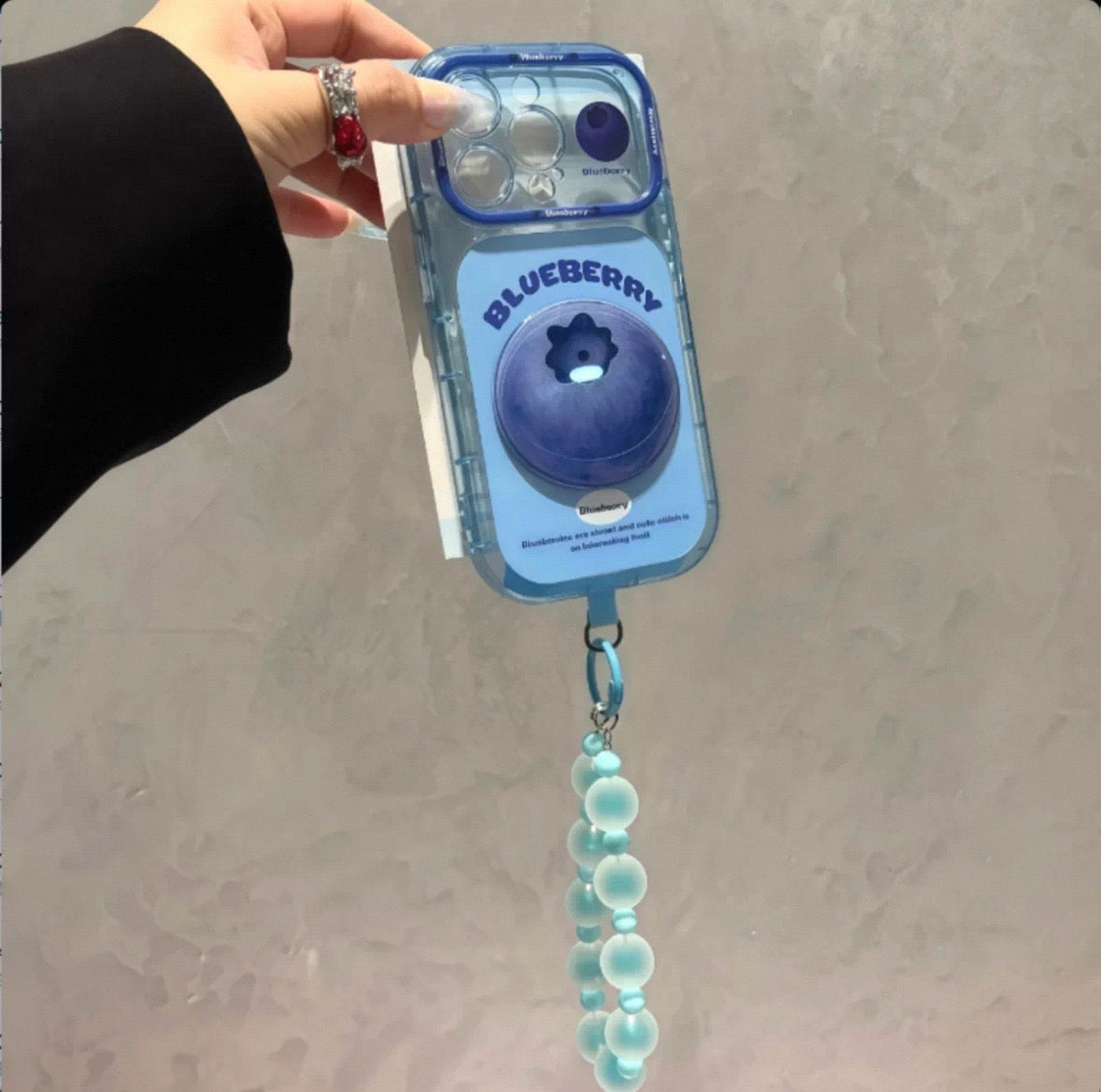 Phone case with 3D fruit charms and a hanging chain