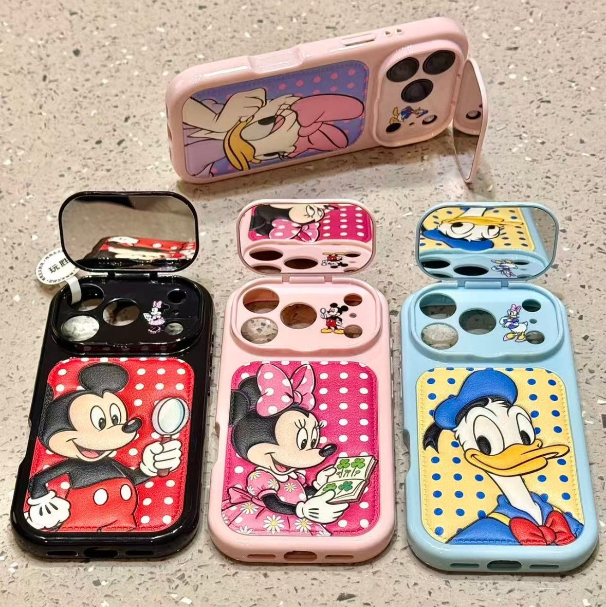 Flip-style mirror phone case featuring Mickey, Minnie, Donald, and Daisy Duck.