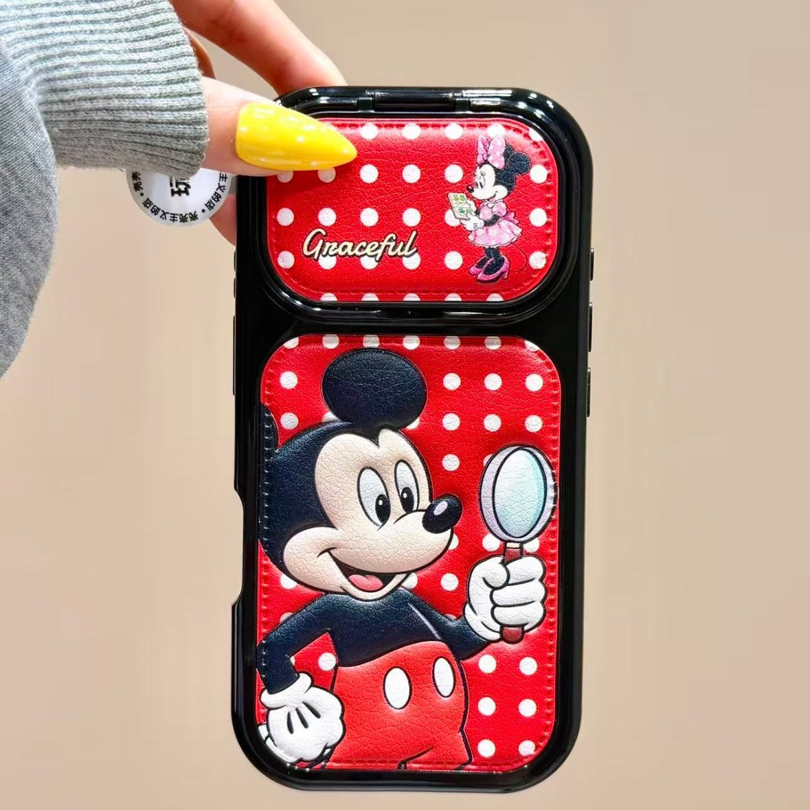 Flip-style mirror phone case featuring Mickey, Minnie, Donald, and Daisy Duck.