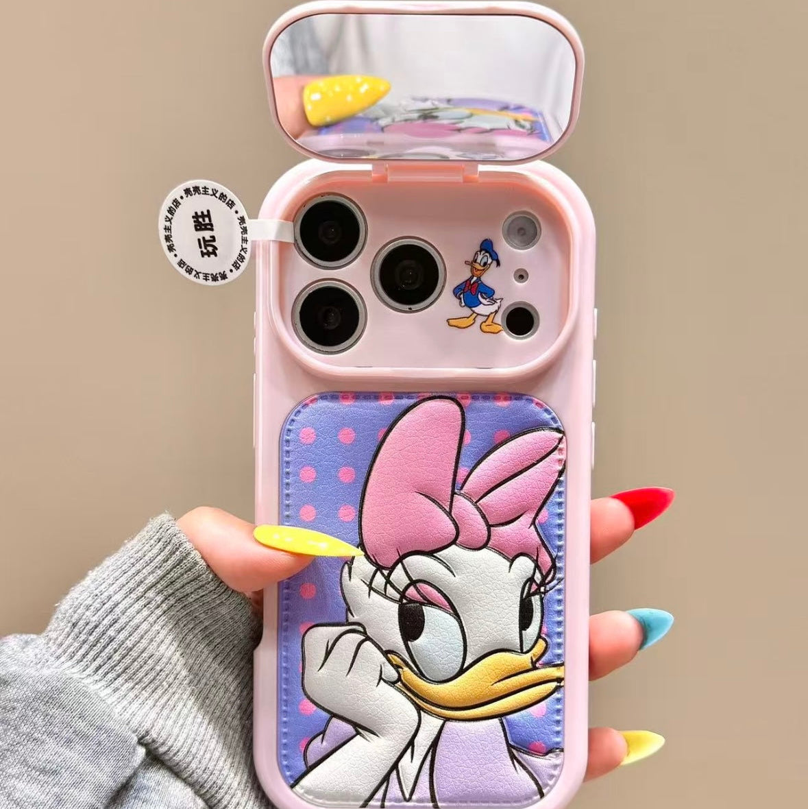 Flip-style mirror phone case featuring Mickey, Minnie, Donald, and Daisy Duck.