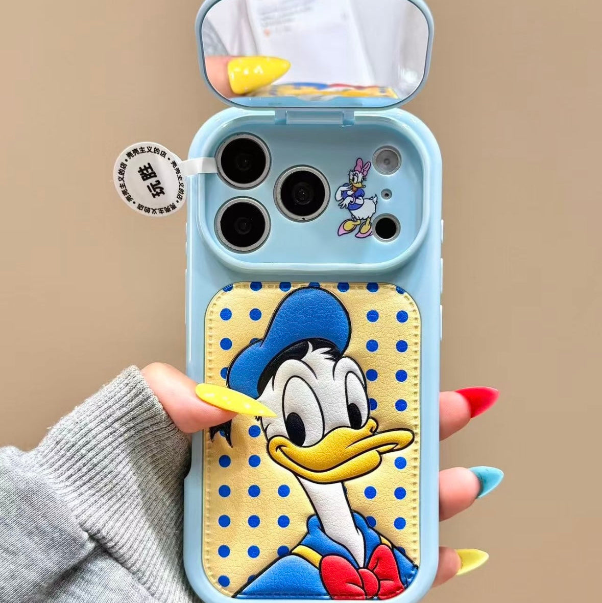 Flip-style mirror phone case featuring Mickey, Minnie, Donald, and Daisy Duck.