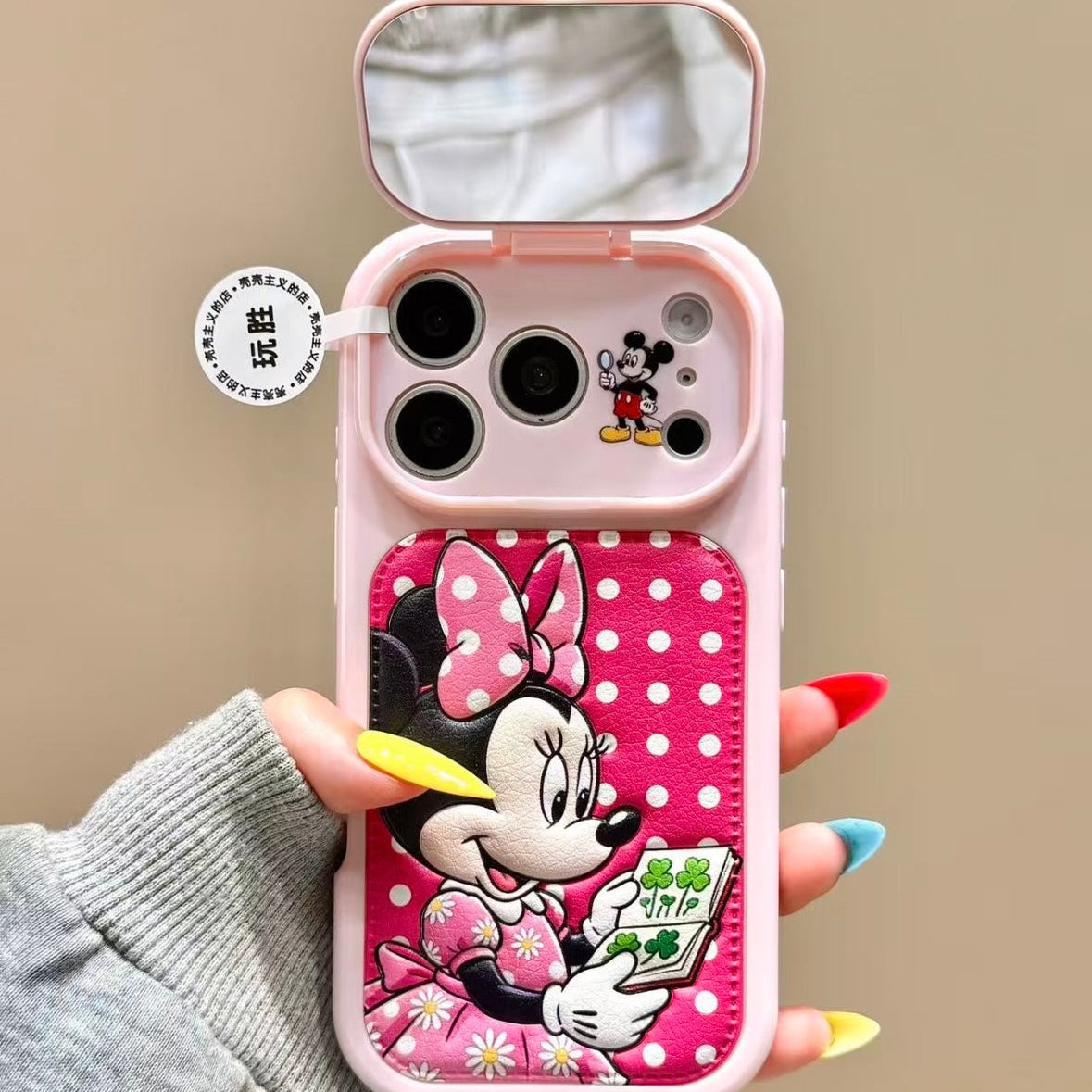 Flip-style mirror phone case featuring Mickey, Minnie, Donald, and Daisy Duck.