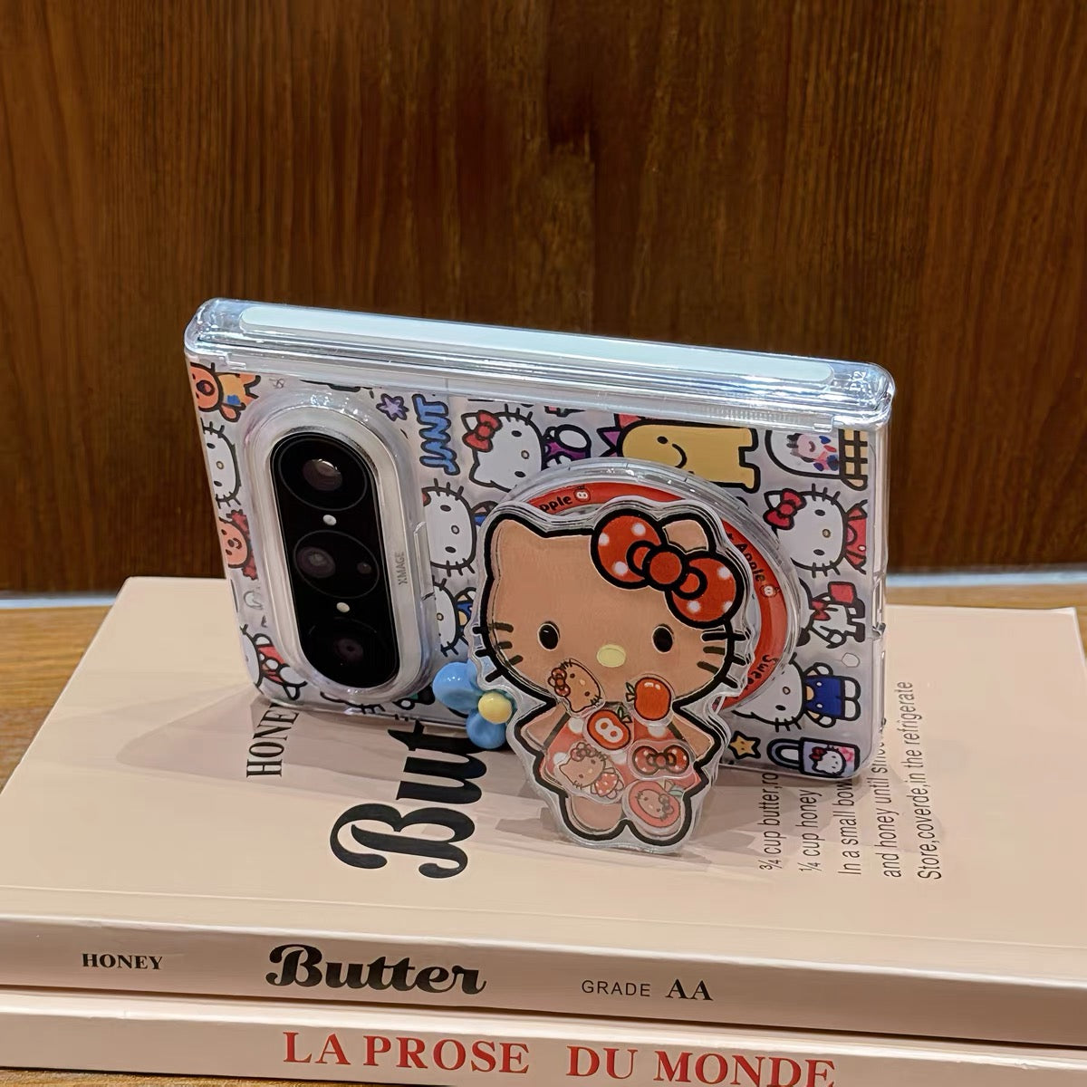 Full-screen Hello Kitty magnetic foldable phone case with a shaker element.