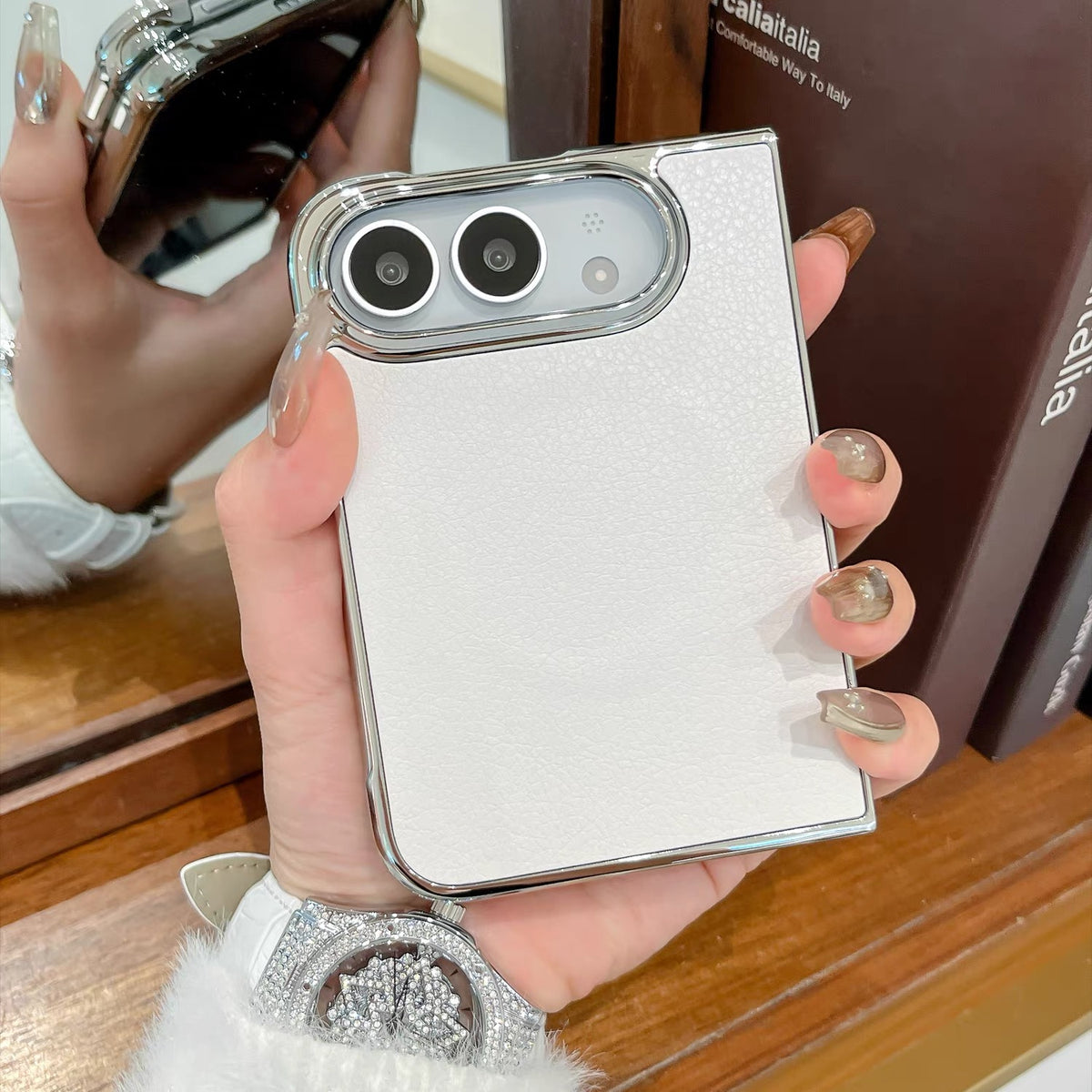 Minimalist solid-color leather-style folding phone case for iPhone Duo featuring a magnetic stand and a cartoon Hello Kitty design.