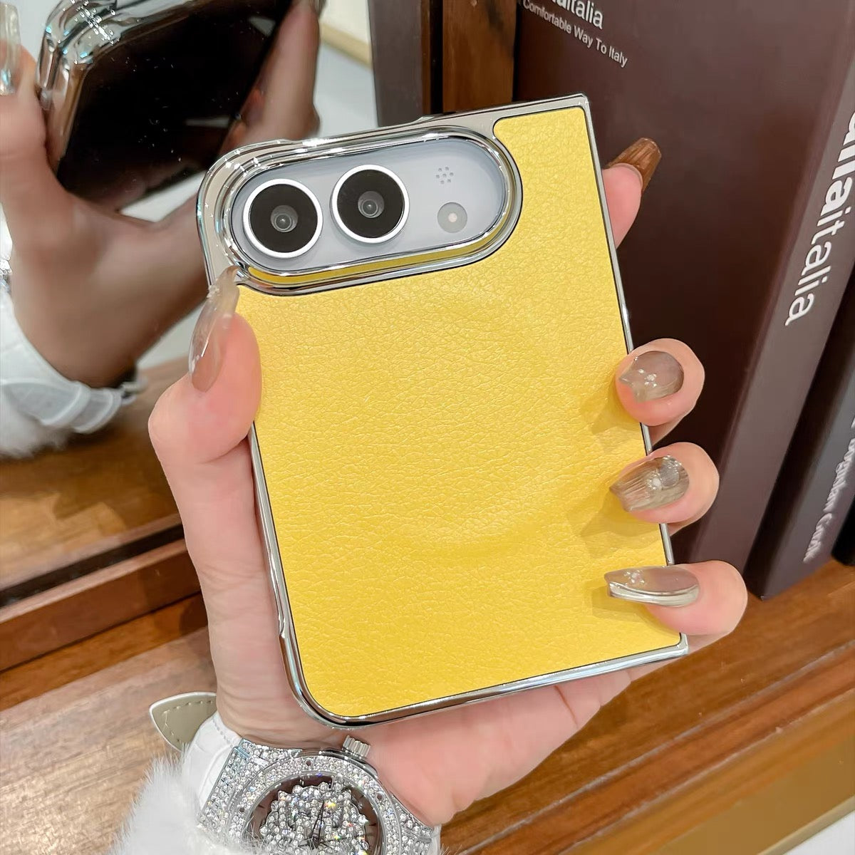 Minimalist solid-color leather-style folding phone case for iPhone Duo featuring a magnetic stand and a cartoon Hello Kitty design.