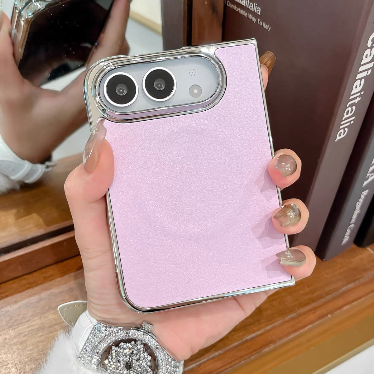 Minimalist solid-color leather-style folding phone case for iPhone Duo featuring a magnetic stand and a cartoon Hello Kitty design.