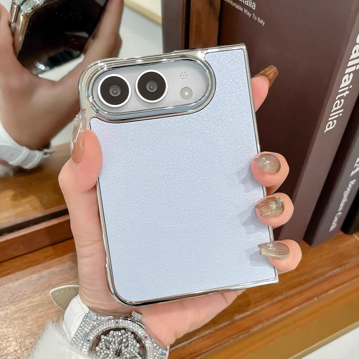 Minimalist solid-color leather-style folding phone case for iPhone Duo featuring a magnetic stand and a cartoon Hello Kitty design.