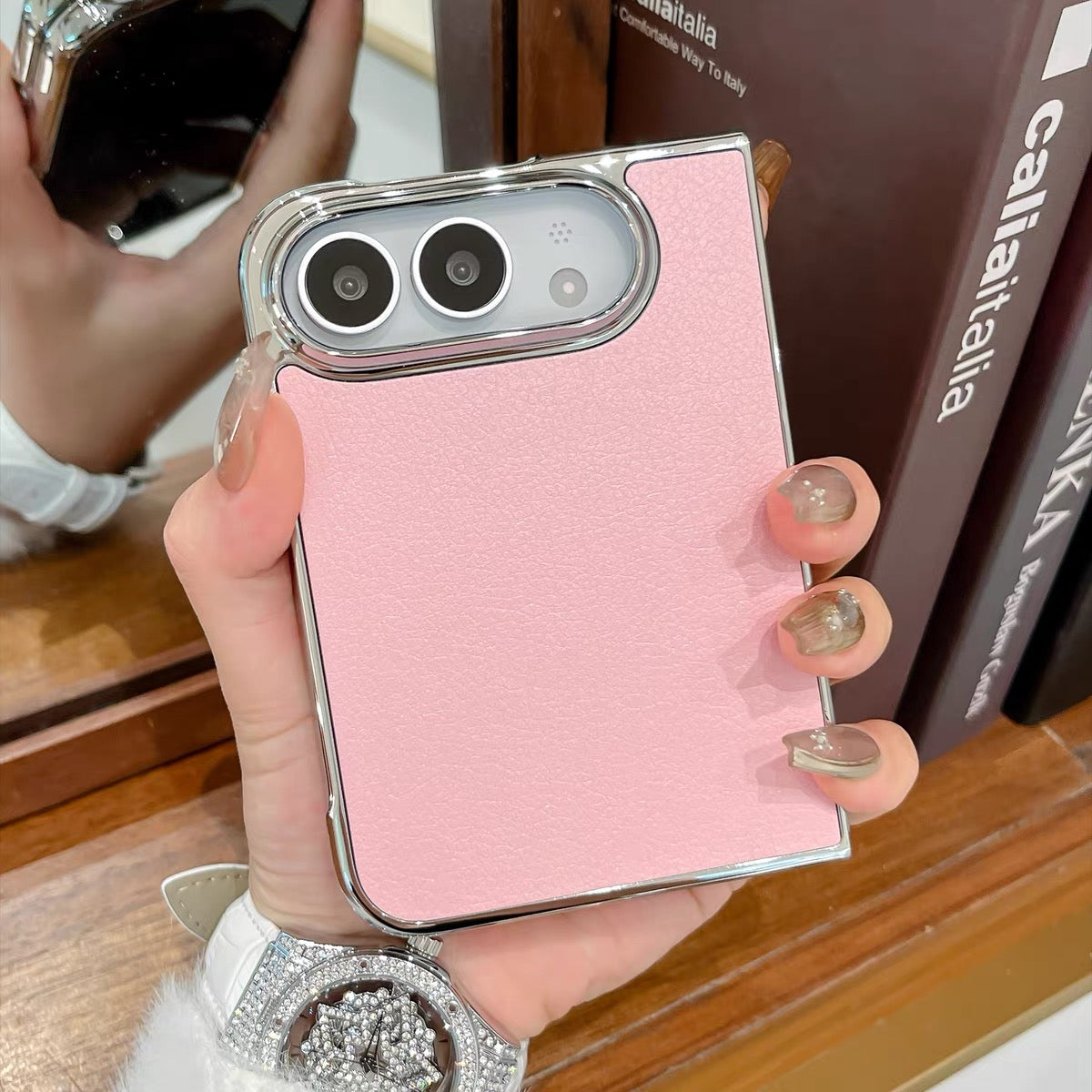 Minimalist solid-color leather-style folding phone case for iPhone Duo featuring a magnetic stand and a cartoon Hello Kitty design.