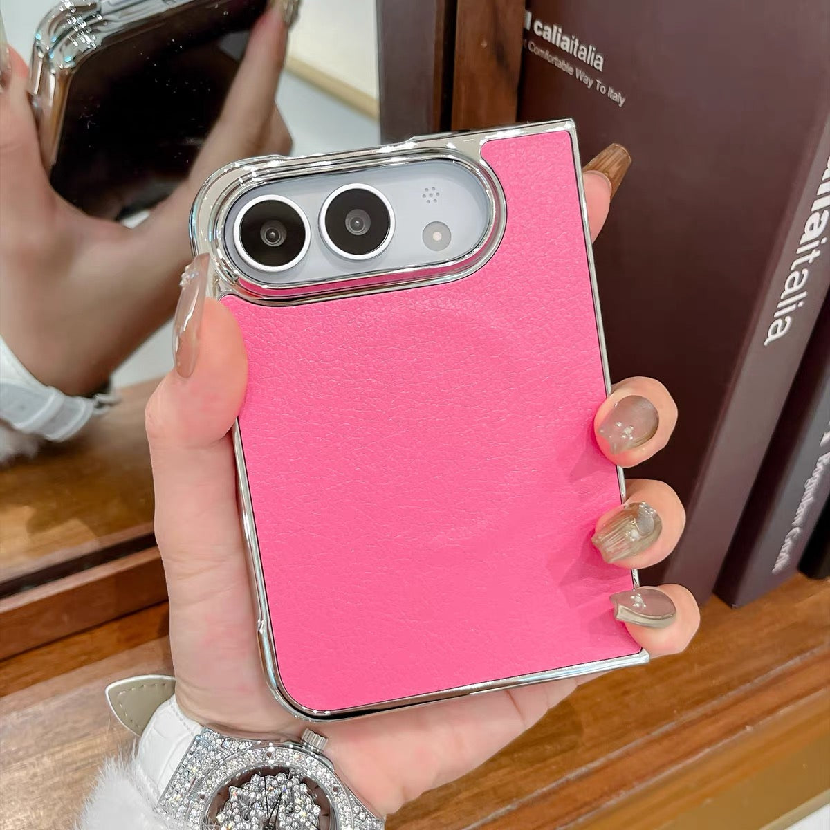 Minimalist solid-color leather-style folding phone case for iPhone Duo featuring a magnetic stand and a cartoon Hello Kitty design.