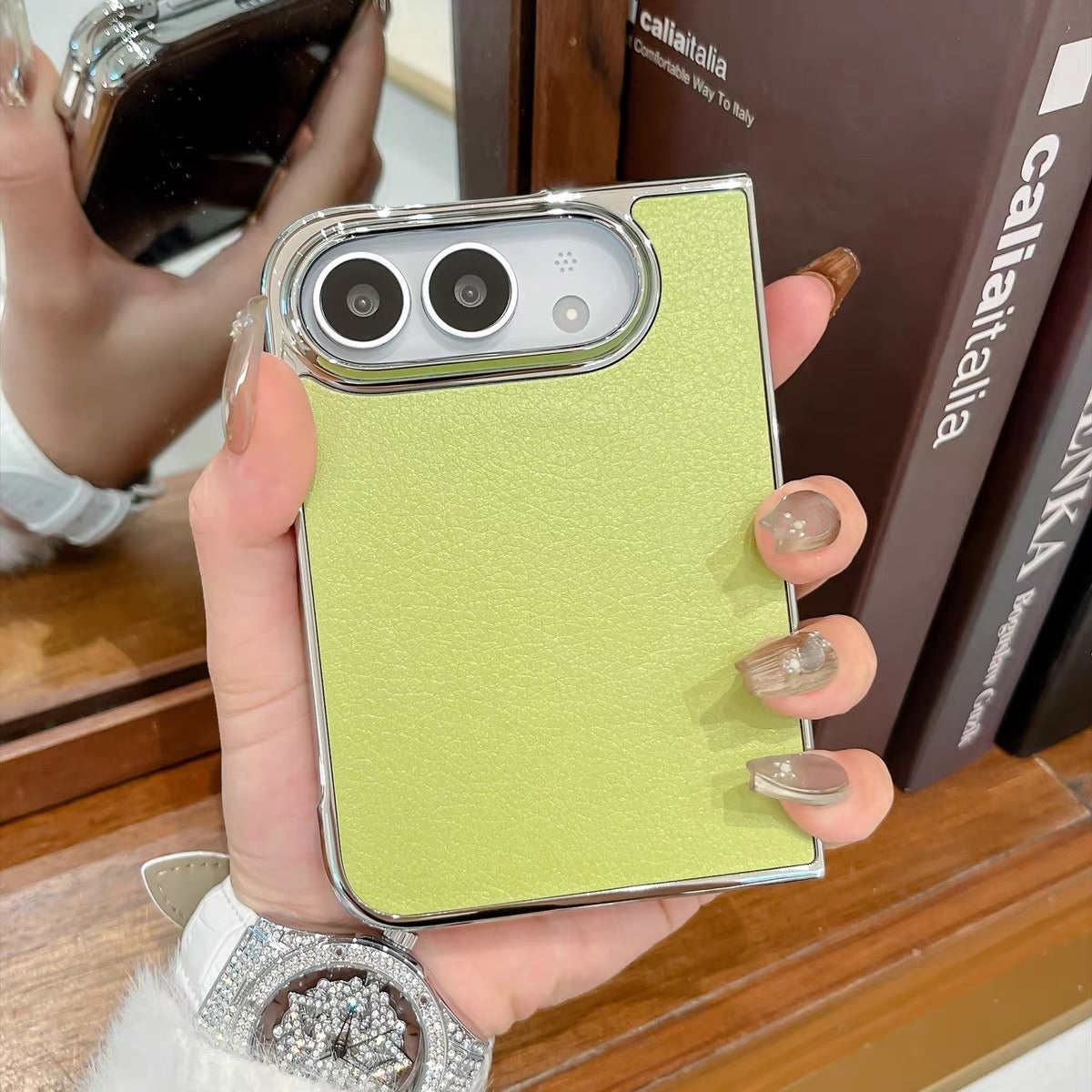 Minimalist solid-color leather-style folding phone case for iPhone Duo featuring a magnetic stand and a cartoon Hello Kitty design.