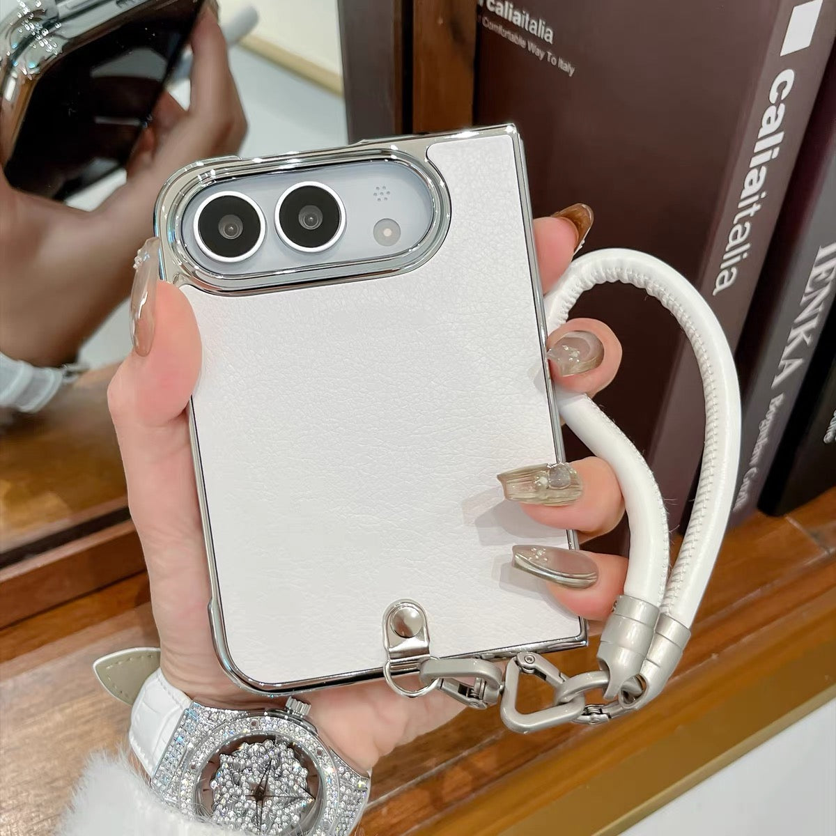 Minimalist solid-color leather-style folding phone case for iPhone Duo featuring a magnetic stand and a cartoon Hello Kitty design.