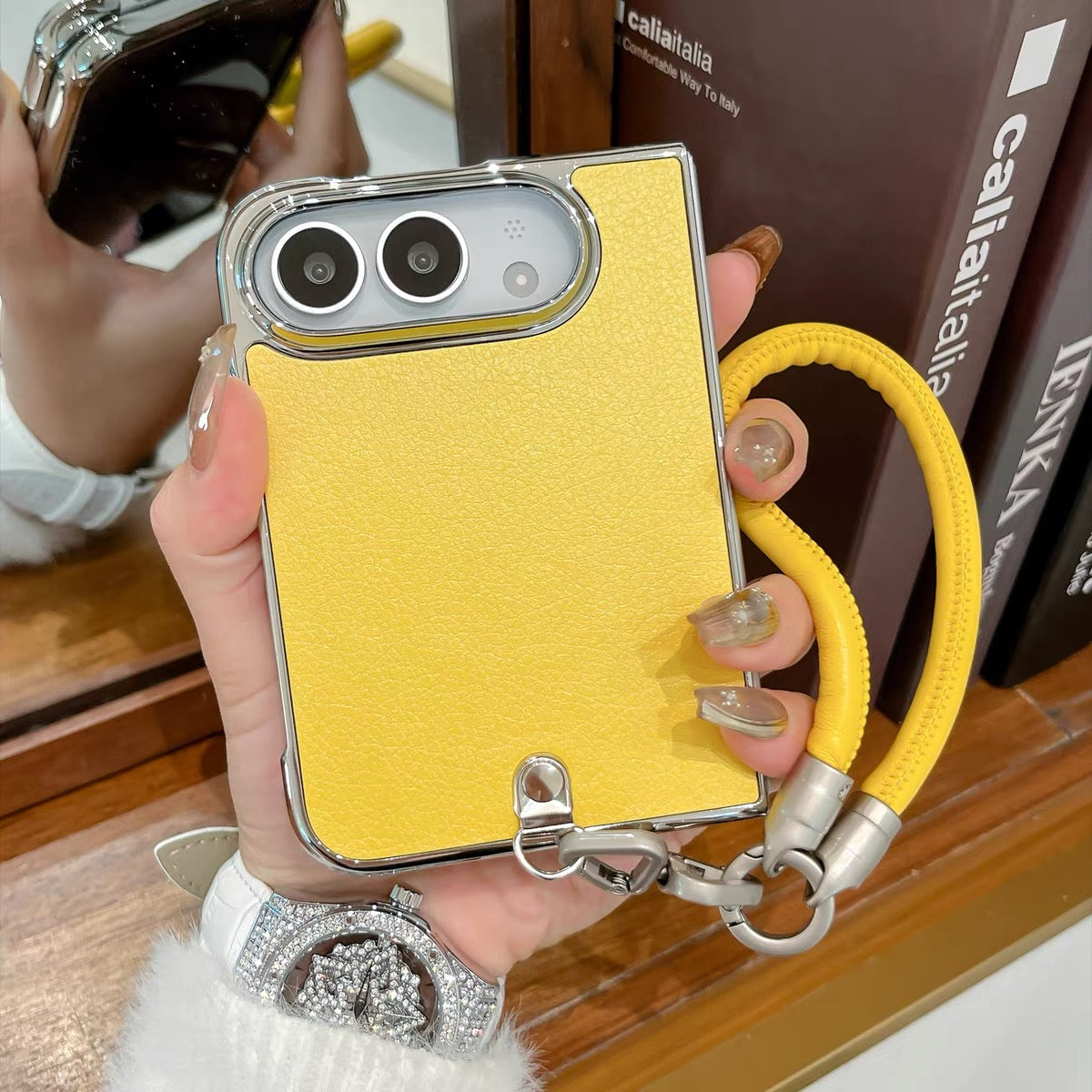 Minimalist solid-color leather-style folding phone case for iPhone Duo featuring a magnetic stand and a cartoon Hello Kitty design.