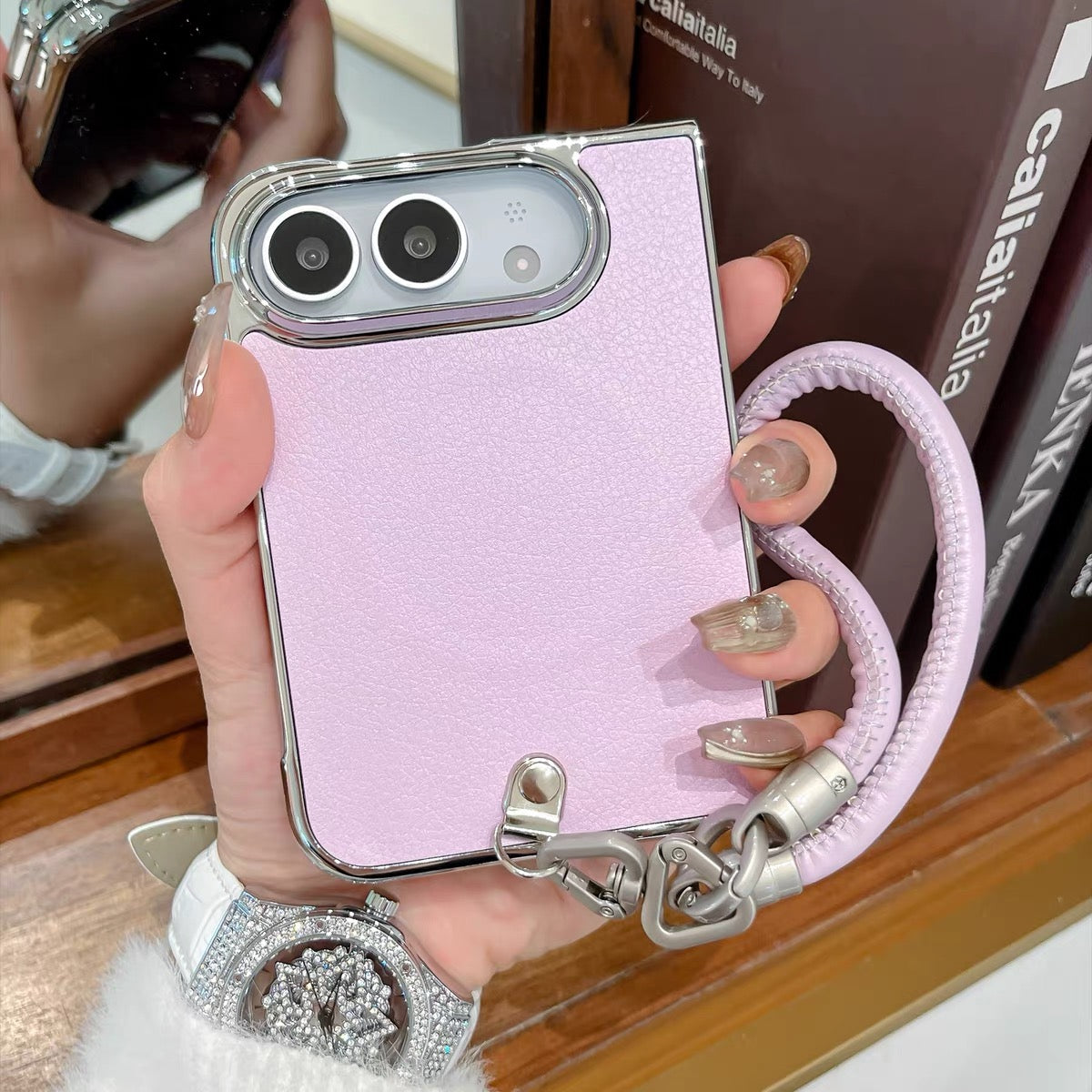 Minimalist solid-color leather-style folding phone case for iPhone Duo featuring a magnetic stand and a cartoon Hello Kitty design.