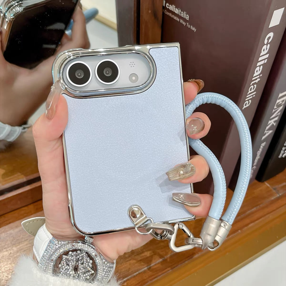 Minimalist solid-color leather-style folding phone case for iPhone Duo featuring a magnetic stand and a cartoon Hello Kitty design.