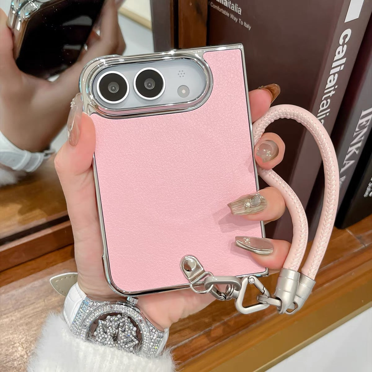Minimalist solid-color leather-style folding phone case for iPhone Duo featuring a magnetic stand and a cartoon Hello Kitty design.