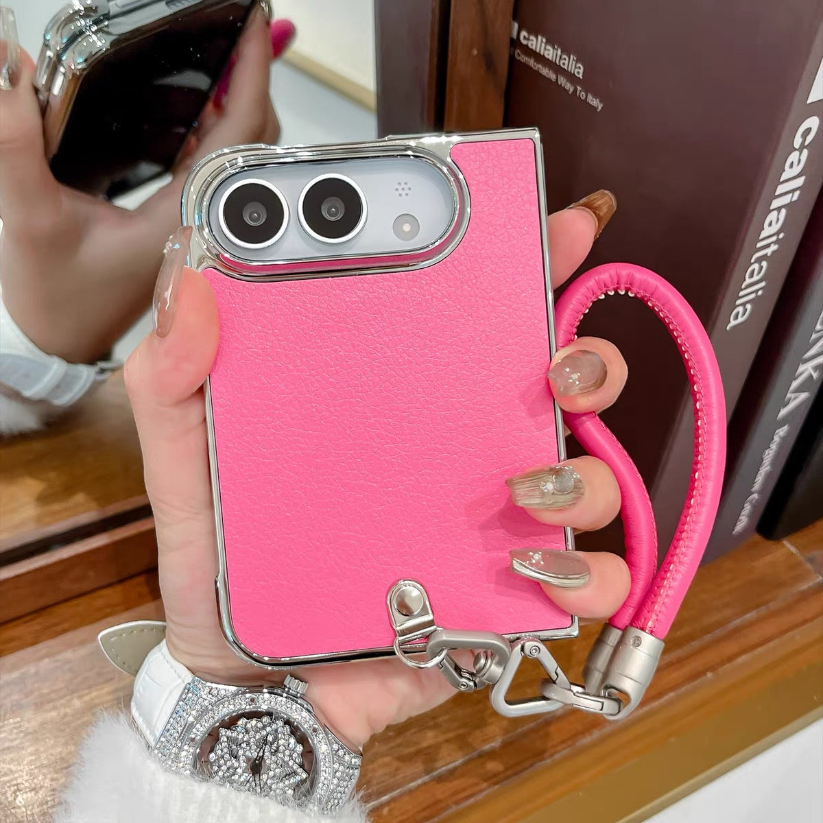 Minimalist solid-color leather-style folding phone case for iPhone Duo featuring a magnetic stand and a cartoon Hello Kitty design.