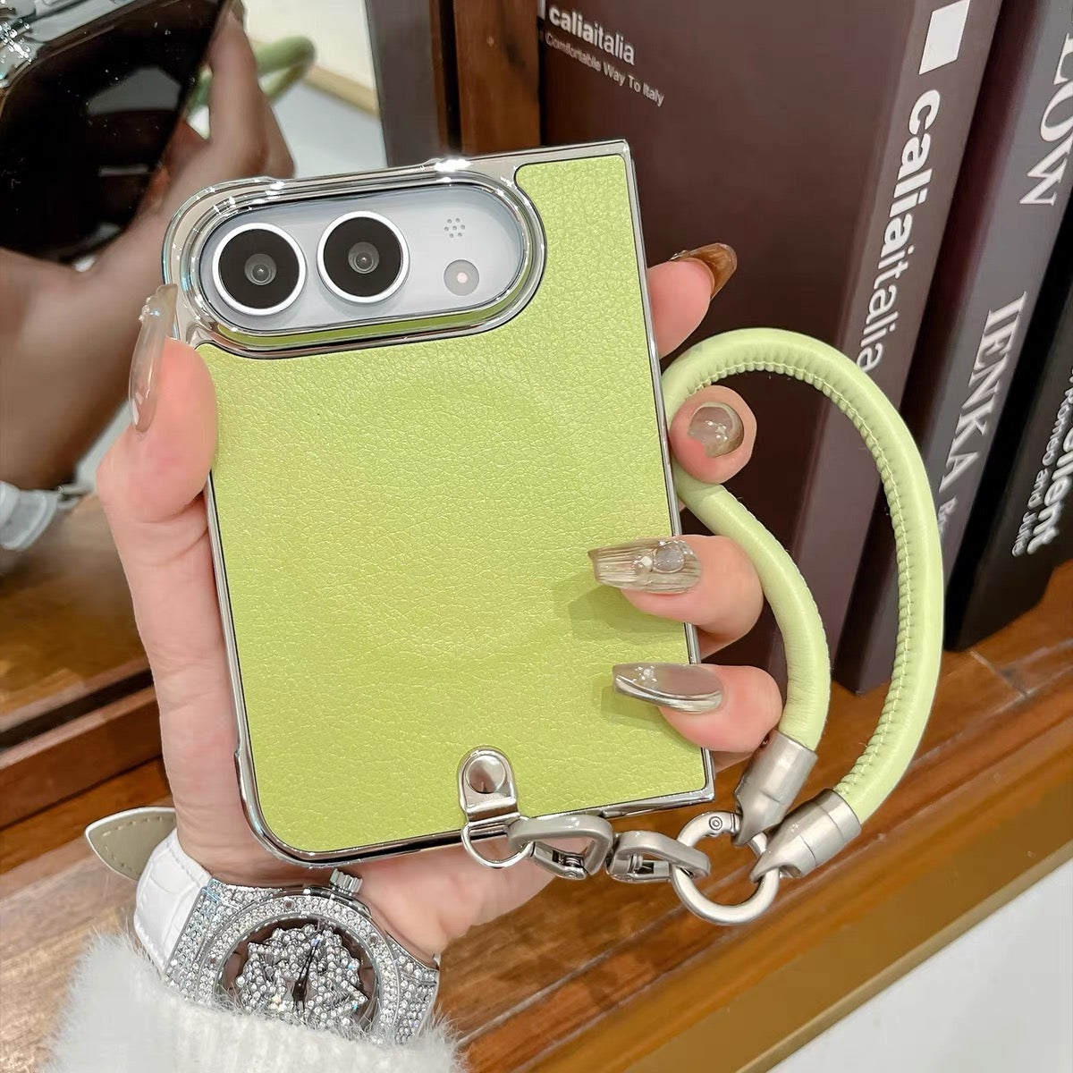 Minimalist solid-color leather-style folding phone case for iPhone Duo featuring a magnetic stand and a cartoon Hello Kitty design.