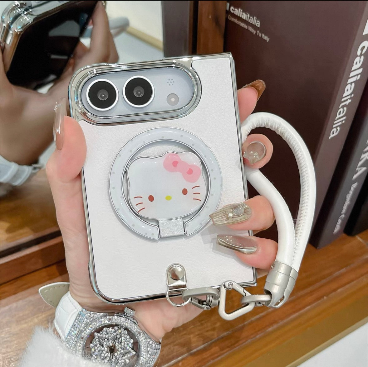Minimalist solid-color leather-style folding phone case for iPhone Duo featuring a magnetic stand and a cartoon Hello Kitty design.