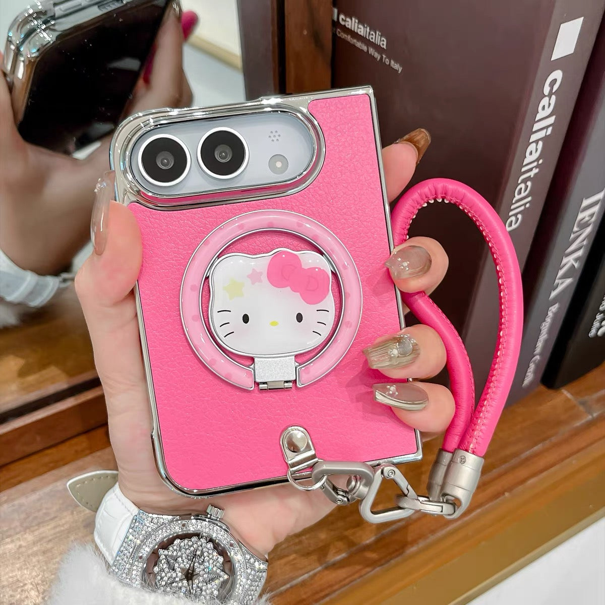 Minimalist solid-color leather-style folding phone case for iPhone Duo featuring a magnetic stand and a cartoon Hello Kitty design.