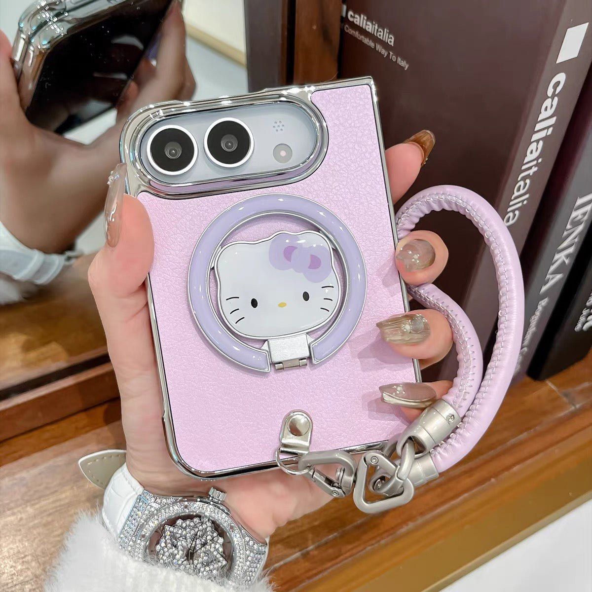 Minimalist solid-color leather-style folding phone case for iPhone Duo featuring a magnetic stand and a cartoon Hello Kitty design.