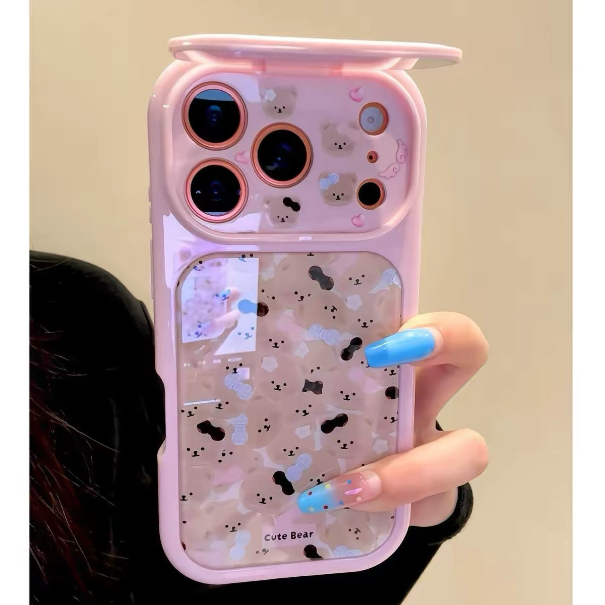Flip-mirror phone case featuring a pink bow and an all-over teddy bear pattern.