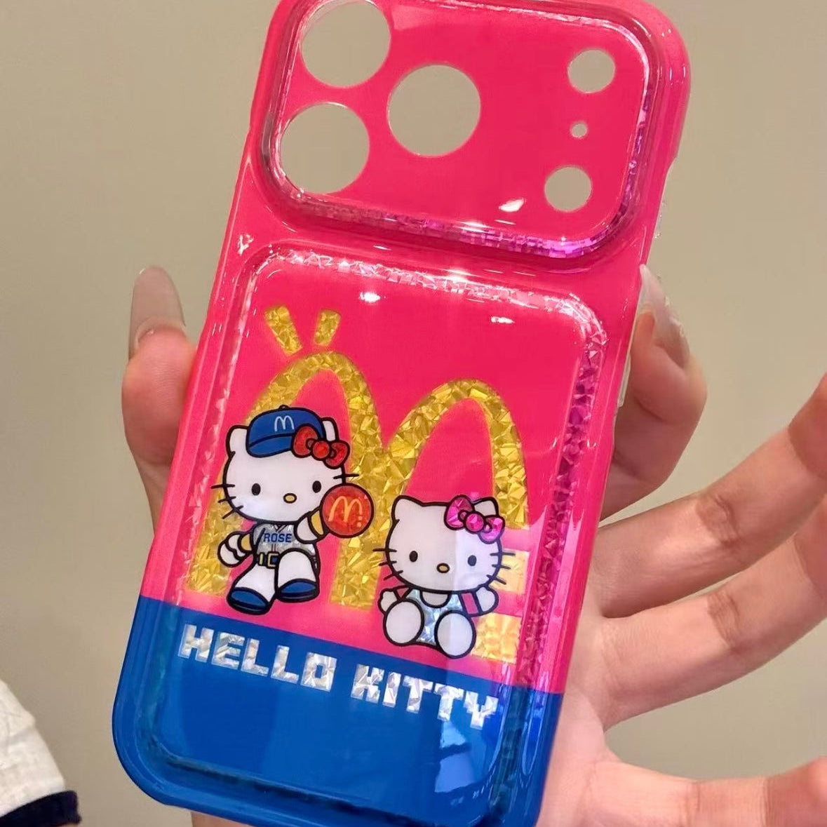 Cartoon Hello Kitty phone case featuring a bow, wings, and a red heart.