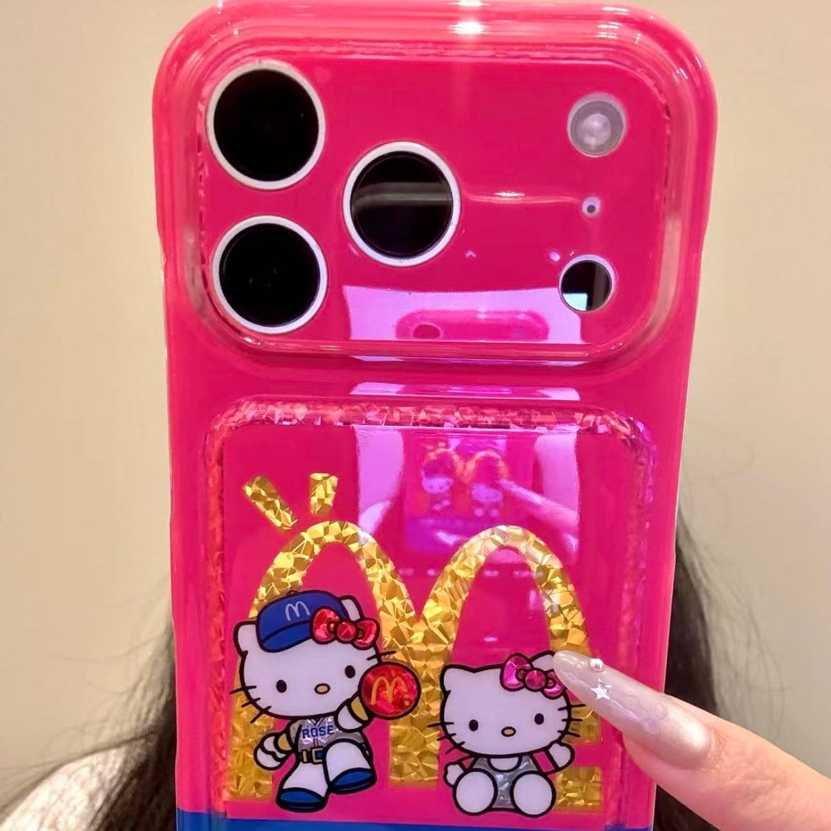 Cartoon Hello Kitty phone case featuring a bow, wings, and a red heart.