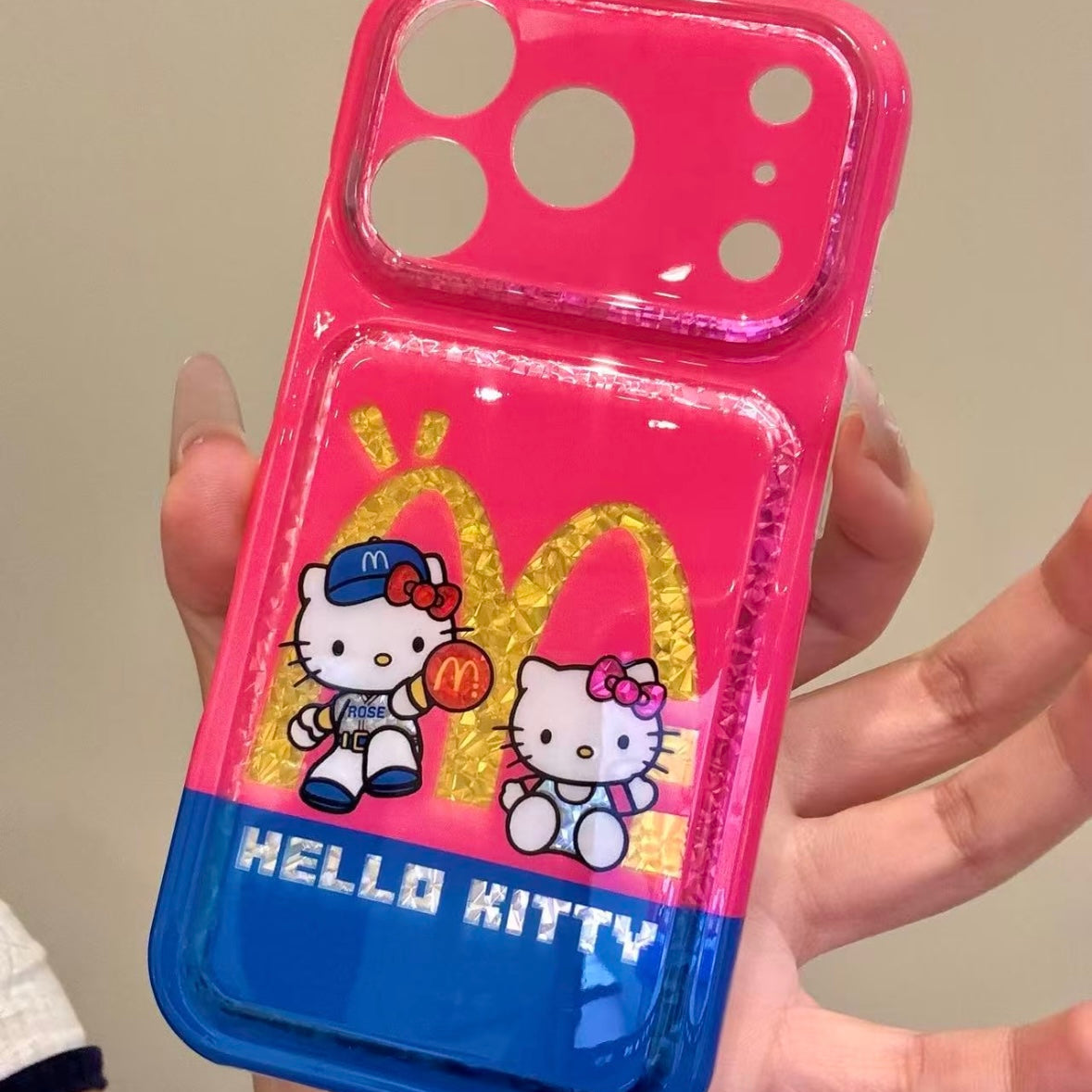 Cartoon Hello Kitty phone case featuring a bow, wings, and a red heart.
