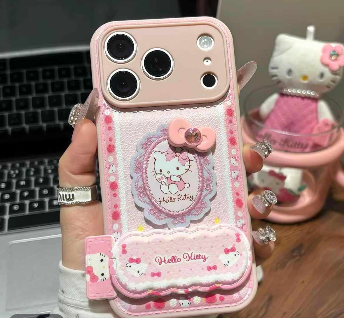 Phone case with lace bow embroidery, Hello Kitty design, and mirror stand.