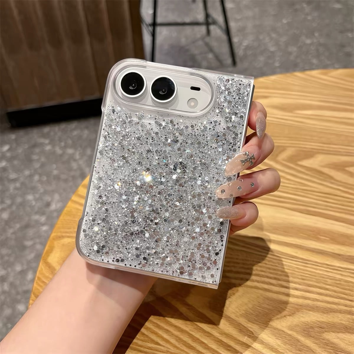 Resin-coated phone case for foldable phones, featuring silver glitter and heart-shaped accents