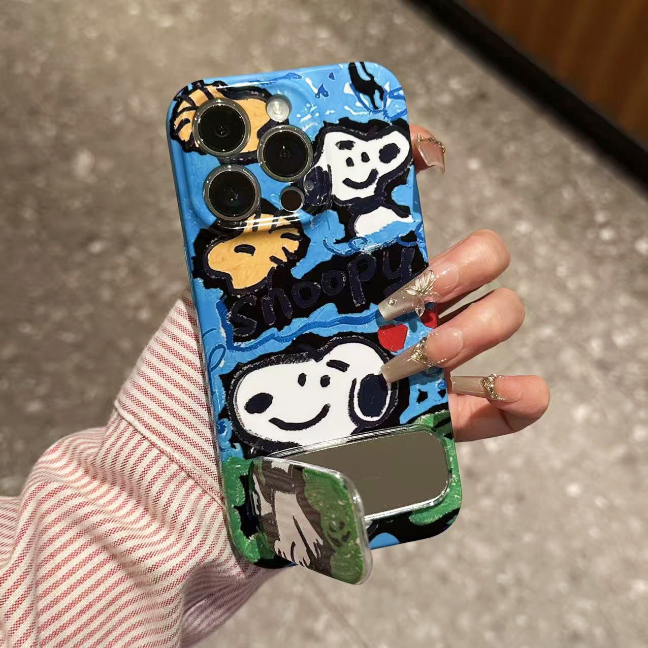 Doodle-style Snoopy phone case with a mirror stand