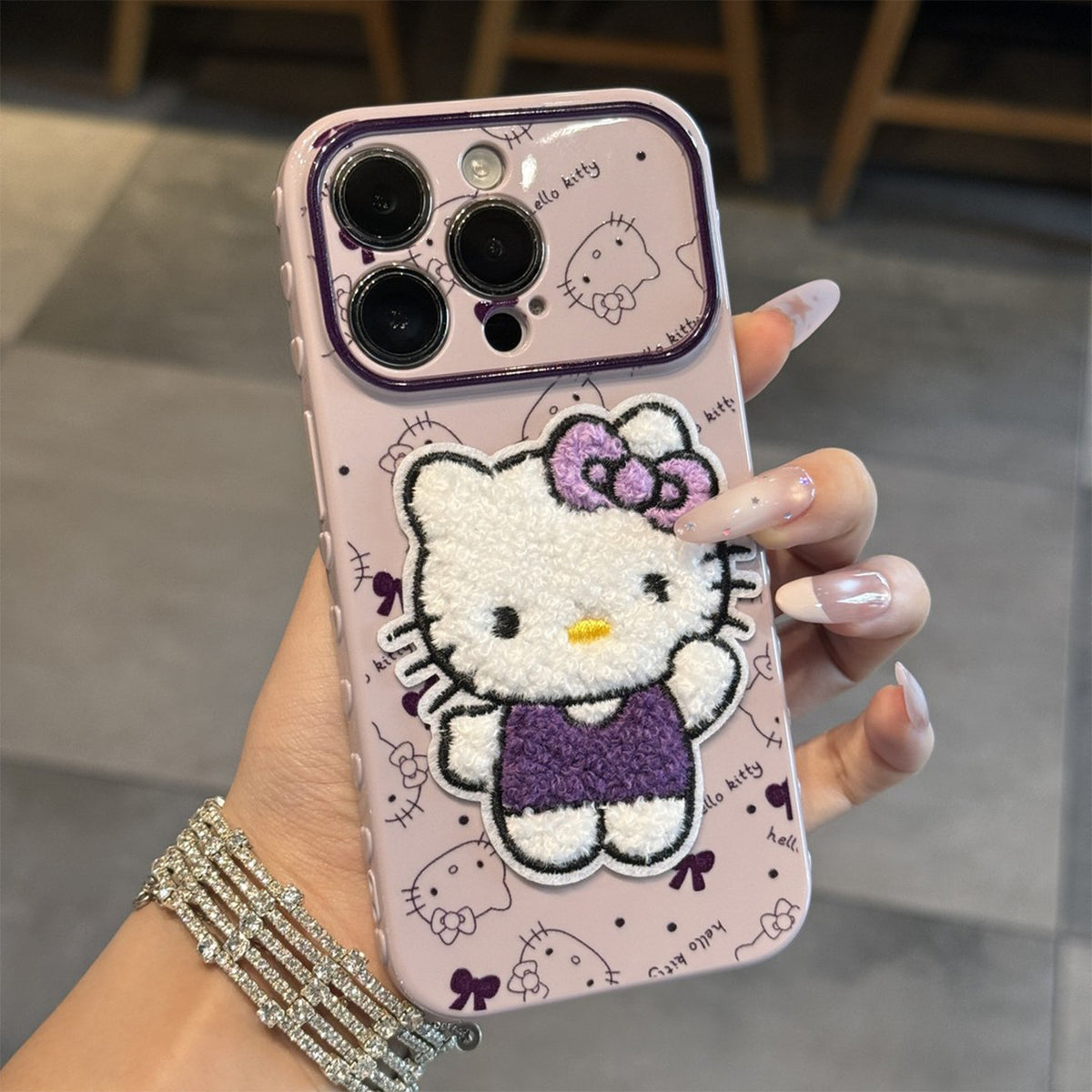 Hello Kitty phone case featuring a pattern of her face all over.